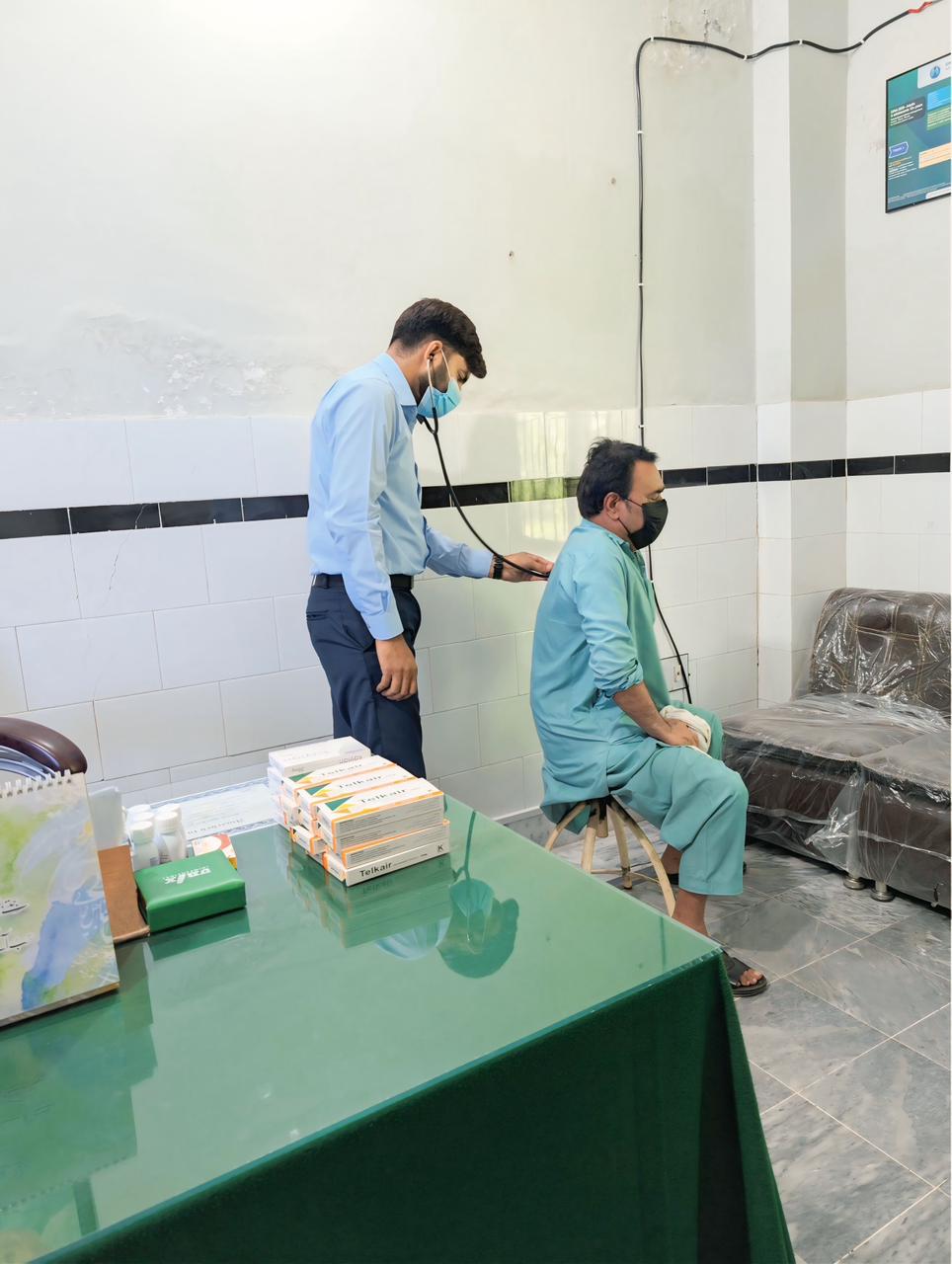 Dr. Mujeeb examining a patient with a stethoscope